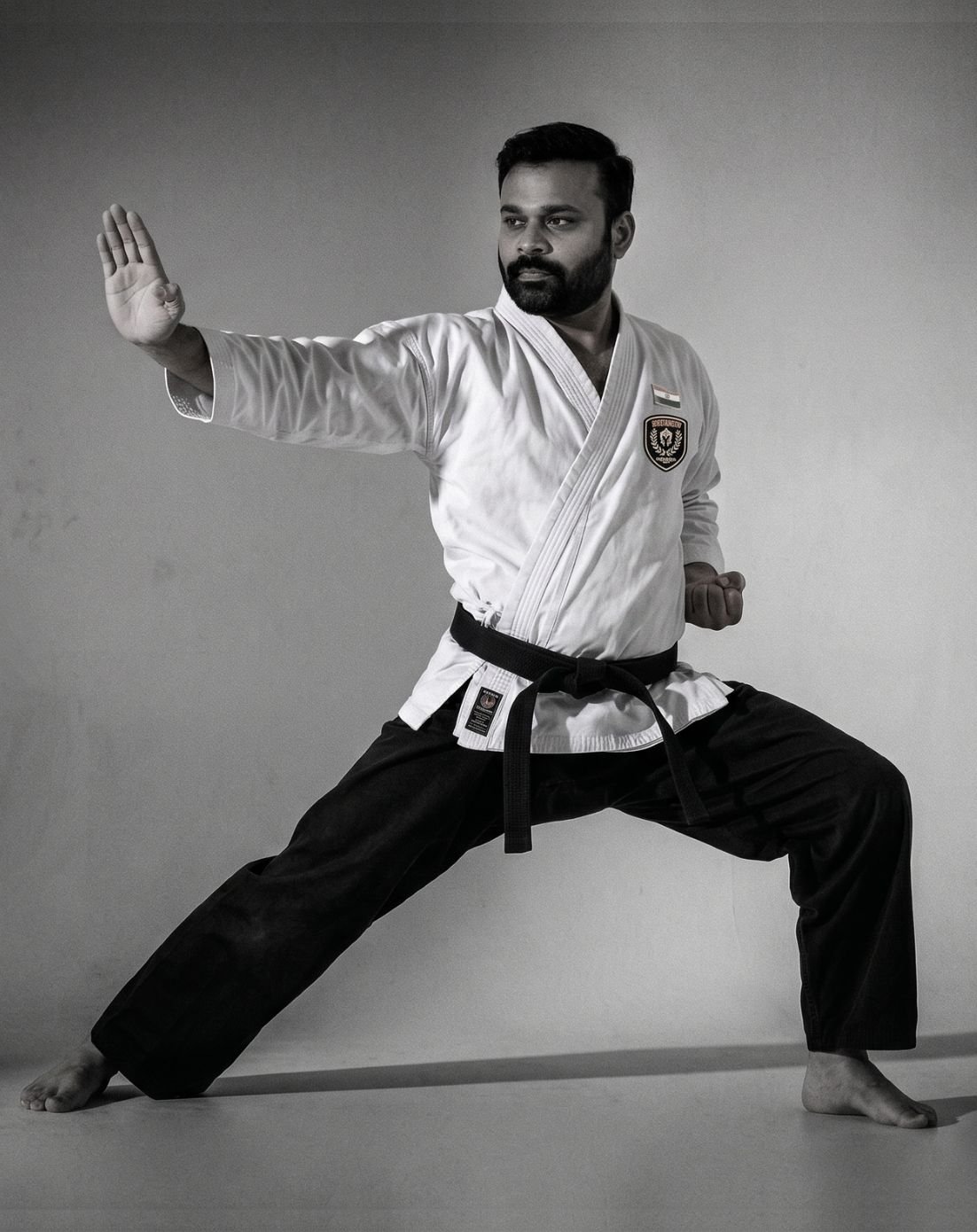 Shihan Nagasa Karthik in a Shito-Ryu Karate fighting stance, wearing his black belt gi